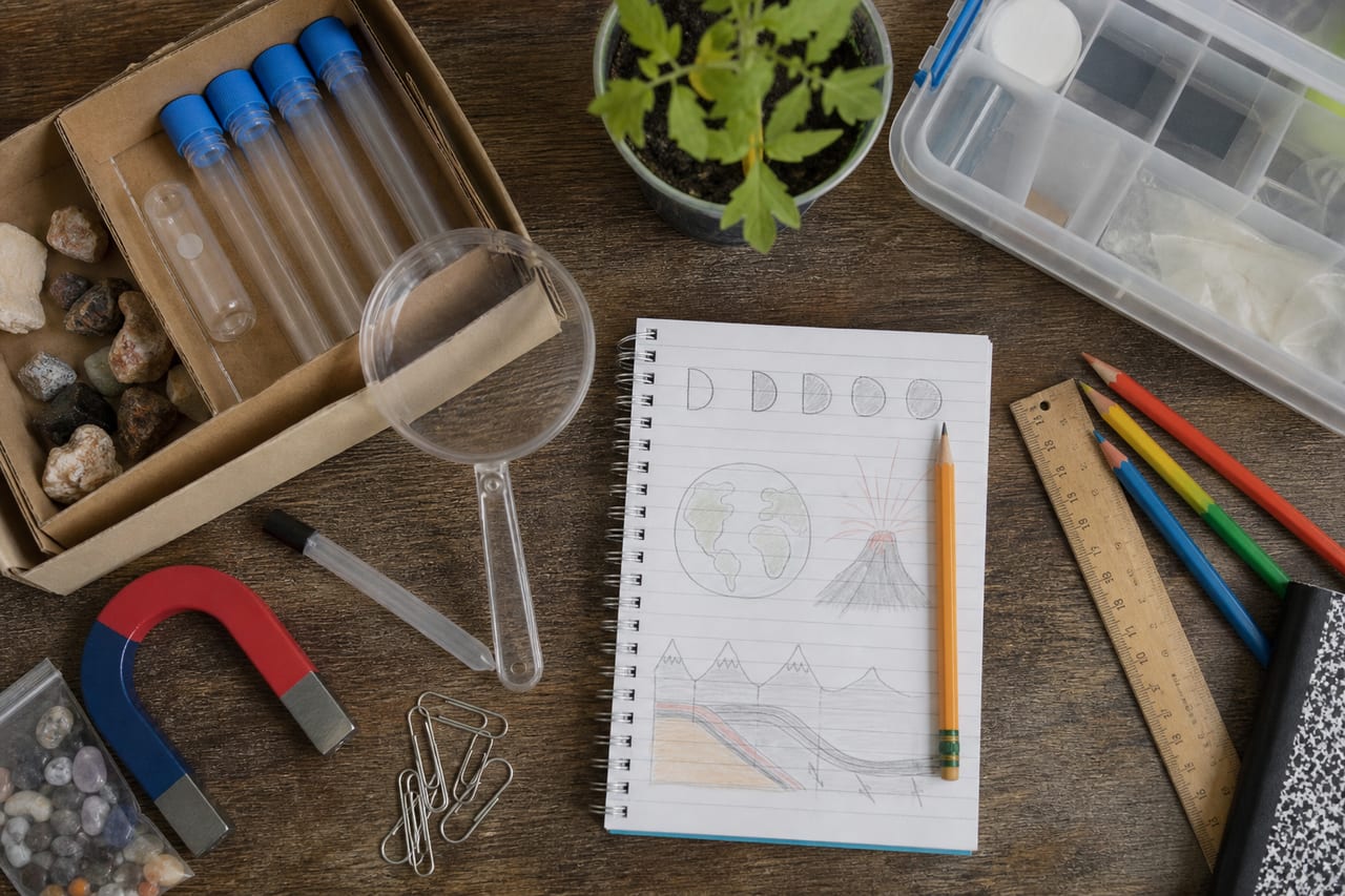 Science and drawing materials arranged on a table